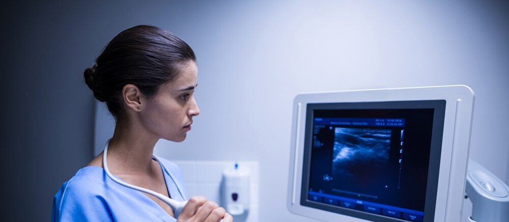 "Female doctor performing diagnostic ultrasound scan at Infinity Heart Hospital Jabalpur"