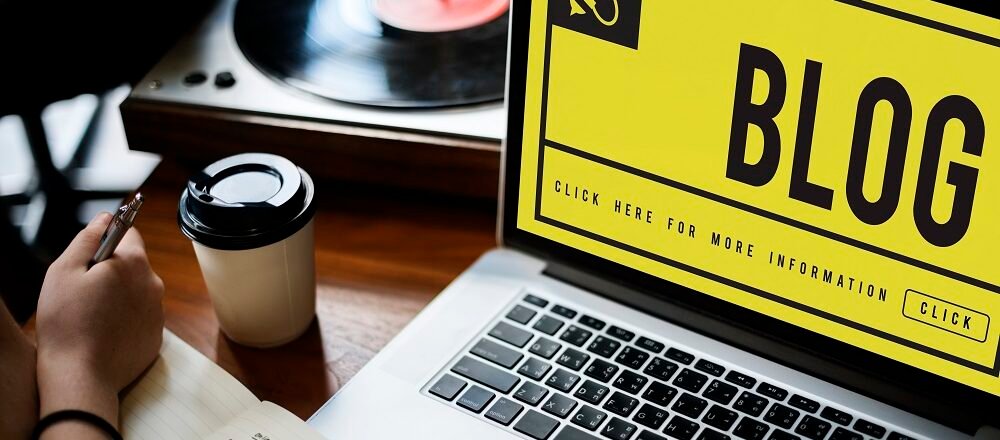 "Laptop displaying BLOG with coffee cup and notes for Infinity Heart Hospital Jabalpur blog writing"