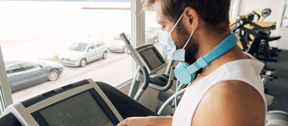 "Man setting treadmill workout in modern gym for heart health at Infinity Heart Hospital Jabalpur"