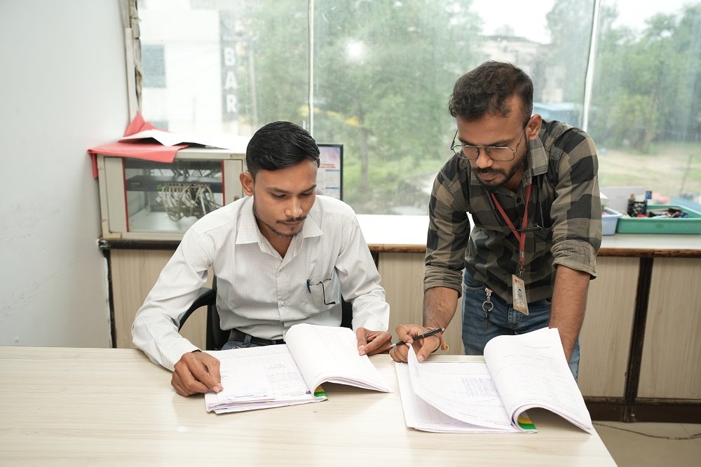 "Hospital staff at Infinity Heart Hospital Jabalpur reviewing documents and records"